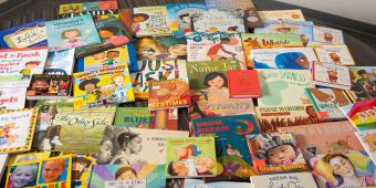 Stack of children's books spread out on table
